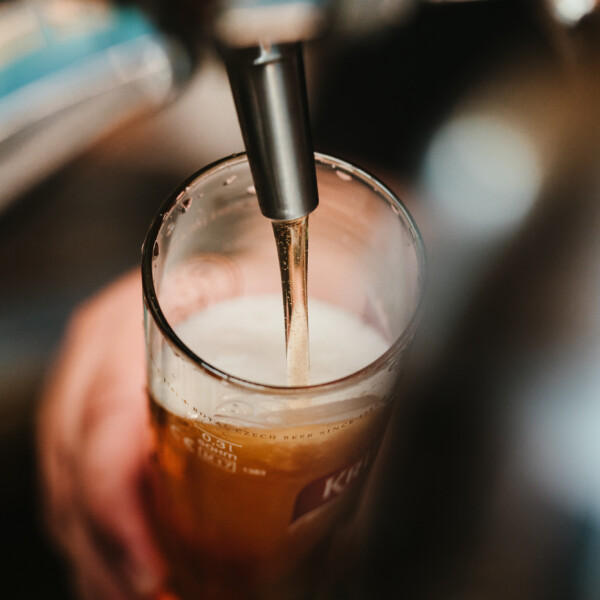 Beer being poured into a glass from a tap at River Bluff Brewing